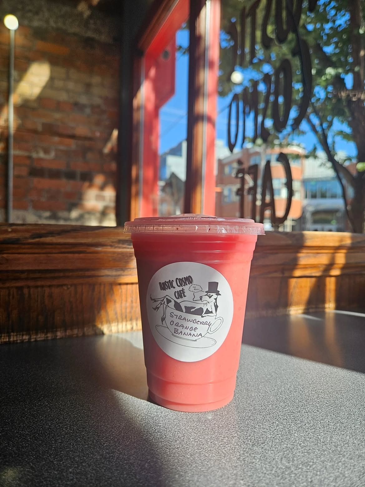 A strawberry-orange-banana drink with the hand-labelled cow sticker