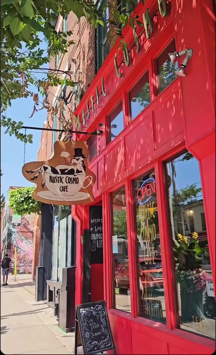 The red Rustic Cosmo storefront on Queen St W with the cow sign hanging out front